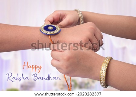 Sister tie Rakhi as symbol of intense love for her brother. celebrated in India as a festival denoting brother-sister love and relationship. Royalty-Free Stock Photo #2020282397