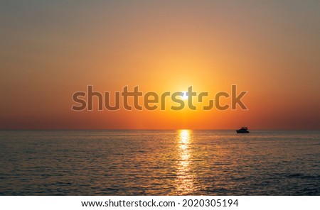 Silhouette of small yacht, ship floating on sea at sunset. Istria, Croatia