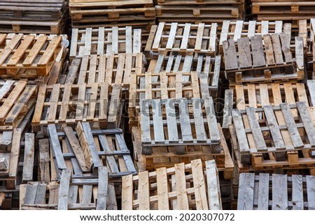 full frame background of used wooden pallet stacks - perspective view from above