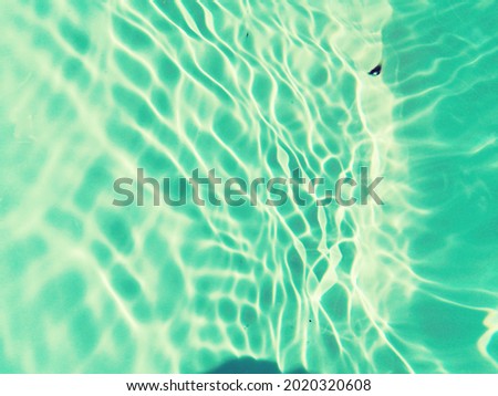 abstract​ of​ surface​ blue​ water. Abstract​ of​ surface​ blue​ water​ reflected​ with​ sunlight​ for​ background.Top​ view​ of blue​ water.​ Water​ splashed​ use​ for​ graphic​ design.