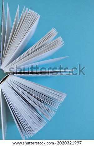 Reading and education . Book close-up on a blue background. Knowledge and Learning. Reading of books. Book pages close-up.Knowledge and education. High quality photo