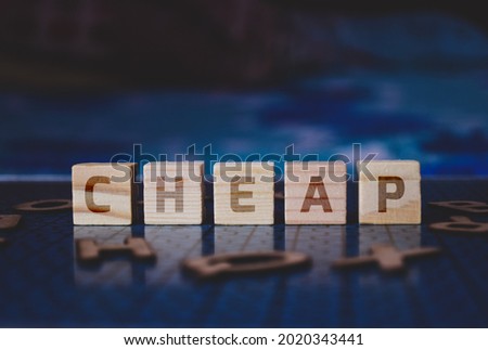 CHEAP text sign on wooden blocks. Concept of pros and cons of investing in penny stock. Selective focus on the blocks.  Royalty-Free Stock Photo #2020343441