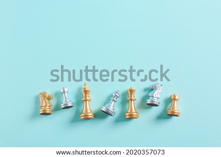 Chess figures on color background Royalty-Free Stock Photo #2020357073