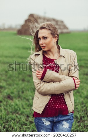 Woman outdoor portrait. Blondie beauty girl in autumn haystacks