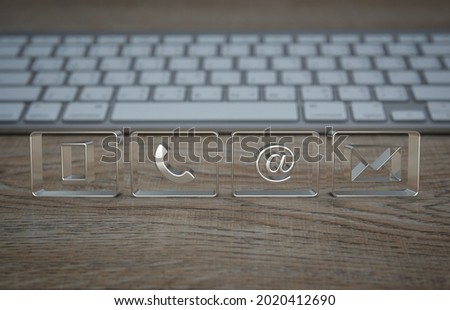 Mobile phone, telephone, email address, email icon on wooden table with computer keyboard, Business customer service and support online concept