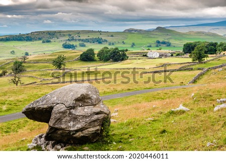 The lonely tree at Winskill stones. Winskill Stones is a nature reserve above the villages of Langcliffe and Stainforth in the Yorkshire Dales Royalty-Free Stock Photo #2020446011