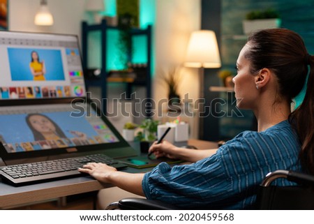 Retouching specialist working on graphic project at studio using modern equipment monitor computer screen stylus digital tablet. Woman with creative occupation doing template for design