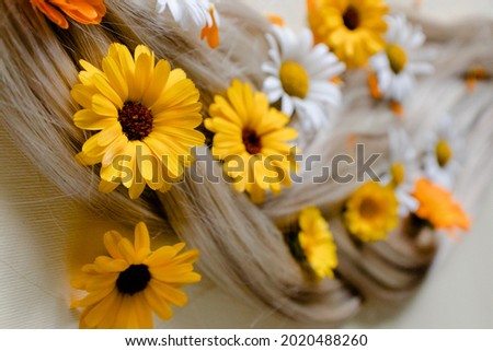 Medicinal flowers with soft blond hair. Summer flowers in hair.