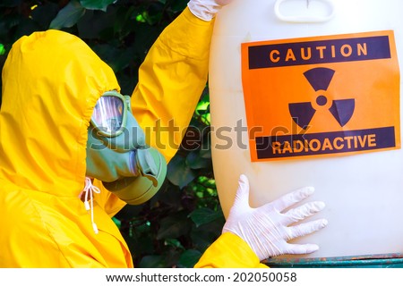 Radioactive waste ; Chemist in protective suit the disposal of radio active waste,photography