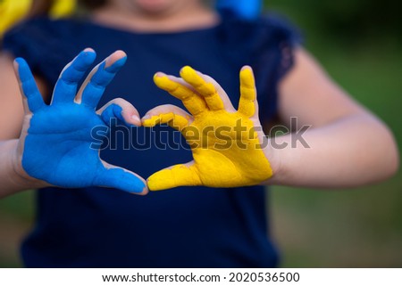 Love Ukraine concept. hands in heart form painted in Ukraine flag color - yellow and blue. Selecrive focus. Independence day of Ukraine, Flag, Constitution day Education, school, art painitng concept Royalty-Free Stock Photo #2020536500