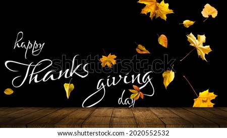 Happy Thanksgiving text with leaves over dark wood background