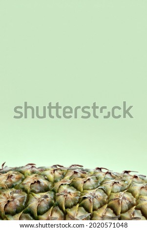 Part of the pineapple close-up on a green background. Place to copy text