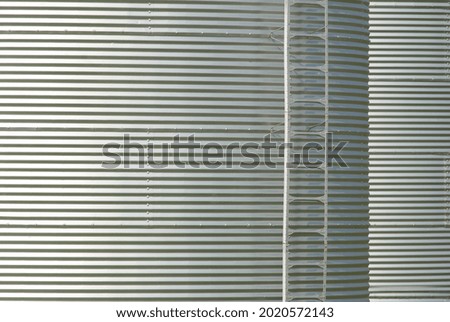 A gray metal surface with stripes
