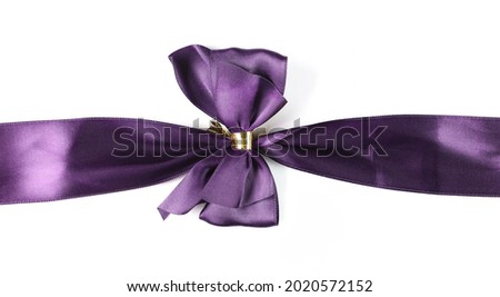 Shiny violet satin ribbon and bow isolated on white background, with clipping path