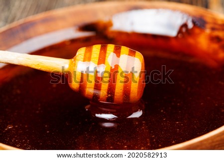 dipped in honey specially made from wood homemade coarse spoon, sweet bee honey and one wooden spoon that allows you to transfer and pour honey without dripping and spreading