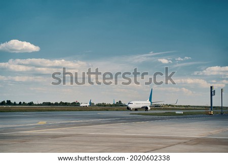 Civil airplanes parked on the runway in the morning Royalty-Free Stock Photo #2020602338