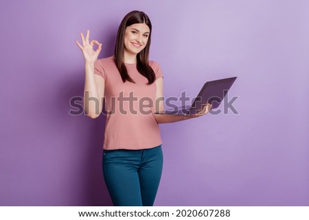 Portrait of positive successful woman happy positive smile show okay alright sign use laptop isolated over violet color background