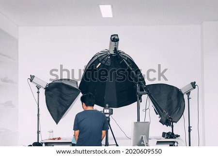 Behind the scene of photoshoot with studio lighting set