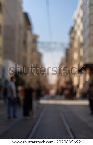 Blur texture background for design. Out of focus views of streets with buildings, people and roads in the city on a sunny summer day
