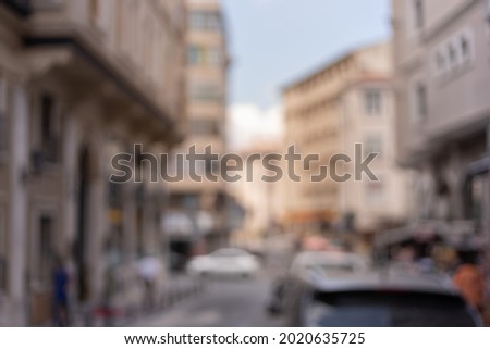 Blur texture background for design. Out of focus views of streets with buildings, people and roads in the city on a sunny summer day