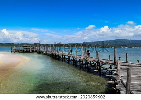 Indonesia, Banten, Pandeglang, 21st July 2017 : wooden bridge to the pier on umang island during the day pandeglang, Banten, Indonesia