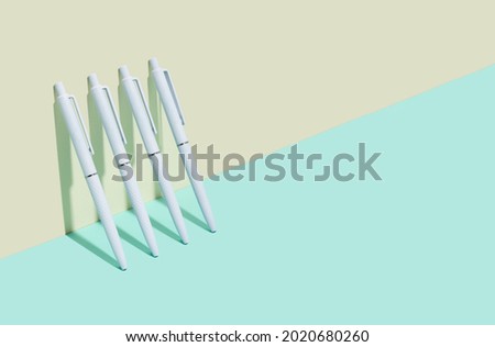 School and office supplies on isometric diagonal proection background. minimum set in ivory, blue, turquoise color: white ball pen. concept: back to school, minimalism. Copy space Royalty-Free Stock Photo #2020680260