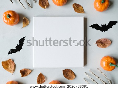 Halloween concept. Blank canvas frame and halloween decoration. Mockup poster. Top view. 