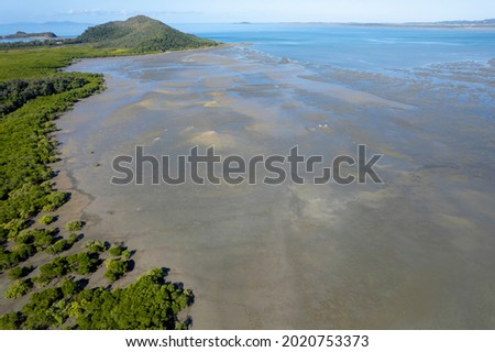 Aerial landscape of shoreline at low tide showing sand and mud flats. Cape Hillsborough, Queensland, Australia