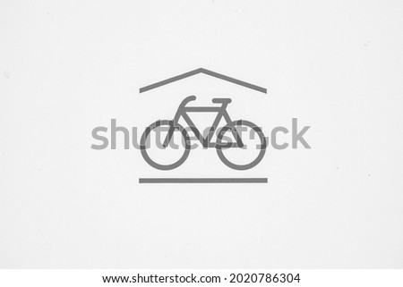 Icon bike shelter. Subtle gray symbol on white background. The sign is located in the center of the image. Plenty of room for copyspace. Royalty-Free Stock Photo #2020786304
