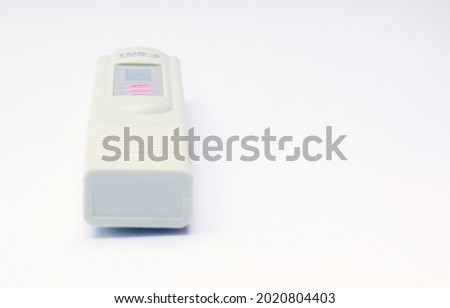 TDS meter isolated on a white background. Water quality control to show total dissolved solids.