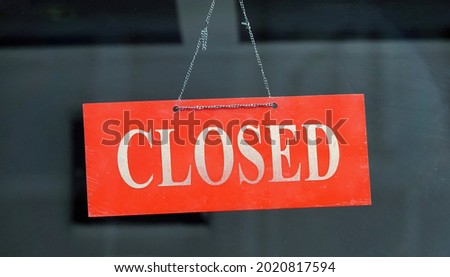 A closeup shot of a red closed sign