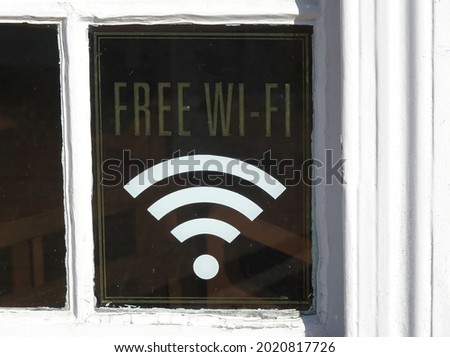 A free wifi sign on a window glass