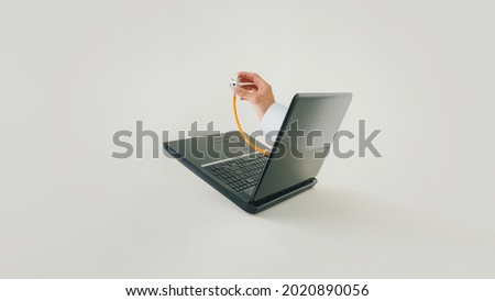 Male hand holds stethoscope from laptop screen on beige background. E-medicine, interactive telemedicine or remote patient monitoring trends. Minimal concept of virtual telehealth or telemonitoring. Royalty-Free Stock Photo #2020890056