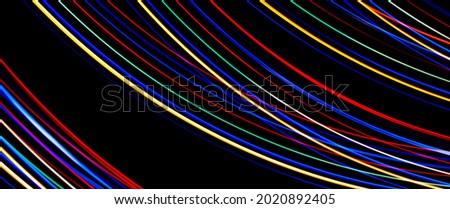 Luminous multicolored wavy lines on a black background