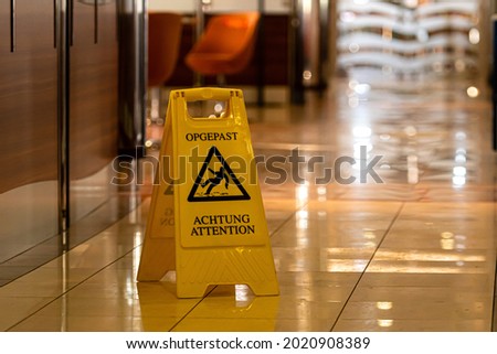 yellow wet floor warning sign and symbol on the passenger ferry restaurant floor
