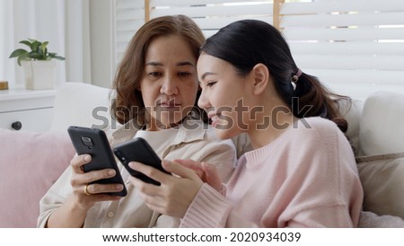 Attractive beautiful asian family sit sofa couch living room enjoy urban life joyful promotion discount shop buy health care insurance online quarantine activity isolate omnichannel experience at home Royalty-Free Stock Photo #2020934039