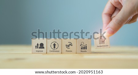 Kaizen concept; the continuous improvement in business for efficiency and effectiveness. Kaizen cycle icon on wood cubes; improve, continuous, process, result, standard solution. Quality improvement.  Royalty-Free Stock Photo #2020951163