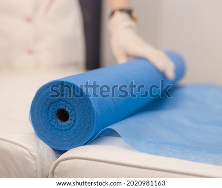 Disposable Beauty Bed Cover. Blue Massage Table Cover Roll. Blue reusable Bed sheet roll.Non Woven Bed Sheet. Royalty-Free Stock Photo #2020981163
