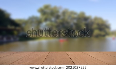 Empty Wood Plate Top Table On Flower And Green Leaf Background