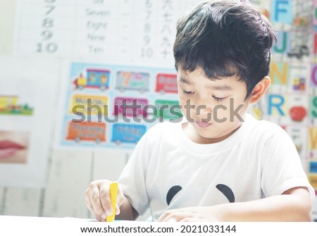 Asian 4 years old toddler boy child stay at home, kindergarten closed during the Covid-19 health crisis, Distance Learning, Online Games, Activities for Kindergarten concept.       