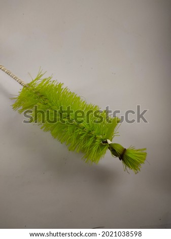 abstract defocused photo of green brush isolated on white background