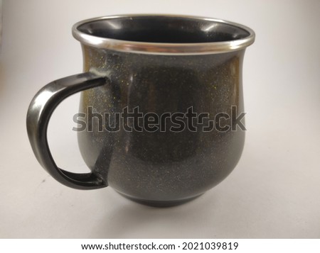 abstract defocused photo of empty black mug isolated on white background