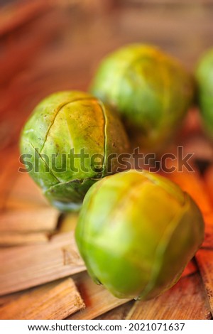 A macro photograph of Brussels sprout in a cane basket.