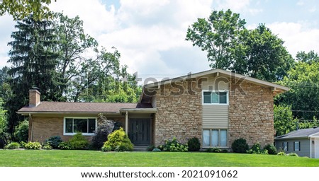 Tan Flagstone House with Various Shrub Landscaping