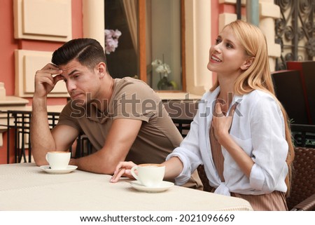 Man having boring date with talkative woman in outdoor cafe Royalty-Free Stock Photo #2021096669