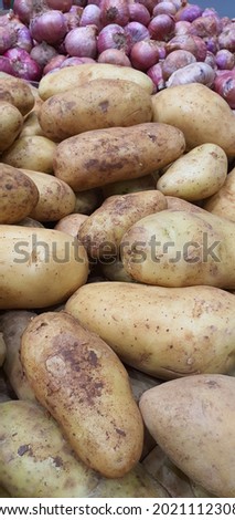 Beautifully presented bunch of fresh potatoes and onions