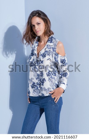 Editorial photography, clothing catalogue, fashion. Blue background. Business woman.