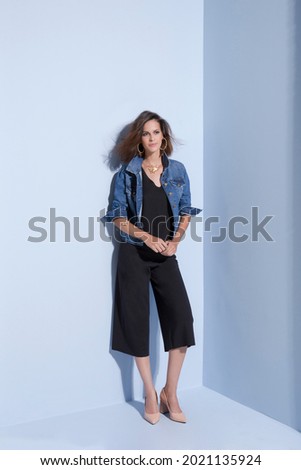 Editorial photography, Women's clothing catalogue, fashion. Blue background. businesswoman