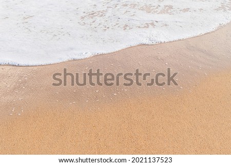 sea foam wave on sandy beach, copy space