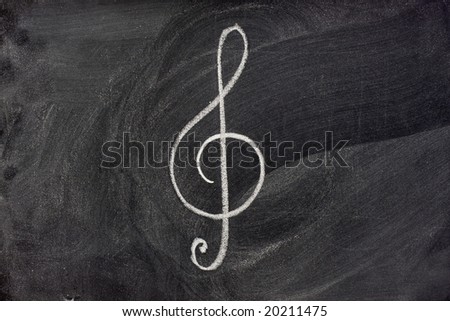 common musical notation sign, treble clef or music symbol in general, sketched with white chalk on blackboard